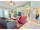 The living room features tile flooring, a ceiling fan, comfortable seating, and an open view to other areas of the home at 974 Forest Hill Dr, Minneola, FL 34715