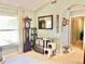 Light-filled living room showcasing a grandfather clock, decorative chest, and neutral tile flooring at 974 Forest Hill Dr, Minneola, FL 34715