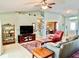 Inviting living room featuring tile flooring, a ceiling fan, comfortable seating, and an open view to other areas of the home at 974 Forest Hill Dr, Minneola, FL 34715