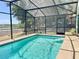 Sparkling in-ground pool with screened enclosure, perfect for enjoying outdoor recreation and relaxation at 974 Forest Hill Dr, Minneola, FL 34715