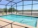 Screened in pool with a full view of the tree-lined backyard at 974 Forest Hill Dr, Minneola, FL 34715