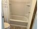 Clean bathroom with a tub and shower combo, with neutral tile and fixtures at 1030 Vermont Ave, Lady Lake, FL 32159