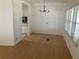 Open-concept dining area with hardwood floors and natural light from a large window at 1030 Vermont Ave, Lady Lake, FL 32159