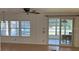 Bright living room featuring large windows and sliding glass doors leading to outdoor area at 1030 Vermont Ave, Lady Lake, FL 32159
