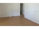 Minimalist room with light hardwood floors, white walls, and a neutral color scheme at 1030 Vermont Ave, Lady Lake, FL 32159