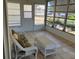 This sunroom features ample windows and comfortable wicker seating at 1030 Vermont Ave, Lady Lake, FL 32159