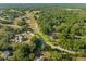 Serene aerial view of homes nestled among lush greenery, offering a private, wooded setting at 111 Kentucky Blue Cir, Apopka, FL 32712