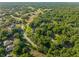 An aerial view reveals the abundance of trees throughout the area, highlighting the property's natural surroundings at 111 Kentucky Blue Cir, Apopka, FL 32712