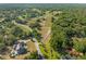 Expansive aerial view showing a rural estate surrounded by lush greenery and neighboring homes at 111 Kentucky Blue Cir, Apopka, FL 32712