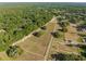 Birds-eye view showing the home site surrounded by lush greenery and fenced land, creating a peaceful rural setting at 111 Kentucky Blue Cir, Apopka, FL 32712