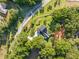 Aerial view of a property featuring a pool, surrounded by lush trees and landscaping at 111 Kentucky Blue Cir, Apopka, FL 32712