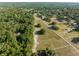An aerial shot highlights the fenced space, accented by mature trees and nearby houses at 111 Kentucky Blue Cir, Apopka, FL 32712