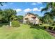 Beautiful backyard with a screened-in pool, a second-story balcony, and lush landscaping at 111 Kentucky Blue Cir, Apopka, FL 32712