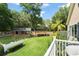 Expansive backyard featuring a barn, white fencing, mature trees, and lush green grass at 111 Kentucky Blue Cir, Apopka, FL 32712
