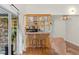 Cozy bar area with wooden cabinets, a sink, and glass sliding doors to the outside at 111 Kentucky Blue Cir, Apopka, FL 32712