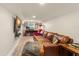 Cozy basement featuring a brown leather couch, large TV, and desk with computer for versatile use at 111 Kentucky Blue Cir, Apopka, FL 32712