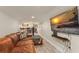 Spacious basement with a large TV, comfortable leather couch, and hardwood flooring for relaxed living at 111 Kentucky Blue Cir, Apopka, FL 32712