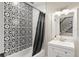 Guest bathroom features stylish black-and-white tilework and an updated vanity at 111 Kentucky Blue Cir, Apopka, FL 32712