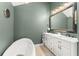 Elegant bathroom with a standalone tub, dual sink vanity, decorative mirror, and green walls at 111 Kentucky Blue Cir, Apopka, FL 32712