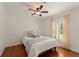 Bright bedroom with a ceiling fan, cozy bed, and large window with shutter blinds, offering natural light at 111 Kentucky Blue Cir, Apopka, FL 32712