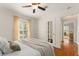 Bright bedroom featuring a double door, white trim and a beautiful hardwood floor at 111 Kentucky Blue Cir, Apopka, FL 32712