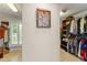 Walk-in closet with custom shelving, hanging clothes, and a sun-lit dressing area at 111 Kentucky Blue Cir, Apopka, FL 32712