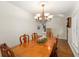 Formal dining room features a large wooden table, chandelier, and window with natural light at 111 Kentucky Blue Cir, Apopka, FL 32712