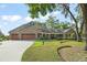 Charming two-story home with a stone facade, well-manicured lawn, and welcoming front porch at 111 Kentucky Blue Cir, Apopka, FL 32712