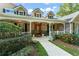 Charming home with a stone facade, welcoming front porch, and well-manicured landscaping at 111 Kentucky Blue Cir, Apopka, FL 32712