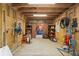 The barn has a well-organized interior with multiple shelves, a repair stand, and fluorescent lighting at 111 Kentucky Blue Cir, Apopka, FL 32712