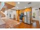 Spacious kitchen featuring stainless steel appliances, wooden cabinetry, and a tiled countertop at 111 Kentucky Blue Cir, Apopka, FL 32712