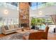 Beautiful living room featuring a stone fireplace and sliding glass doors to a pool area at 111 Kentucky Blue Cir, Apopka, FL 32712