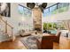 Spacious living room with high ceilings, a stone fireplace, and access to the pool area at 111 Kentucky Blue Cir, Apopka, FL 32712