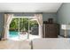 Main bedroom provides direct access to a private pool and lush tropical garden views at 111 Kentucky Blue Cir, Apopka, FL 32712