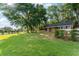 Charming outbuilding with lush green grass, perfect for relaxation or storage needs at 111 Kentucky Blue Cir, Apopka, FL 32712