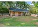 Outbuilding with beautiful black trim doors and a well-manicured lawn on a sunny day at 111 Kentucky Blue Cir, Apopka, FL 32712