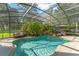Inviting screened-in pool area with lush greenery, a hot tub, and ample space for relaxation at 111 Kentucky Blue Cir, Apopka, FL 32712