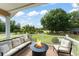 Inviting porch with comfortable seating and a fire pit, overlooking the property's picturesque yard at 111 Kentucky Blue Cir, Apopka, FL 32712