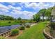 Sprawling backyard with lush lawn, dock, and scenic waterway views at 1110 Fairfax St, Leesburg, FL 34748
