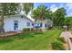 Beautiful backyard showcasing manicured lawn, mature landscaping, and waterfront access at 1110 Fairfax St, Leesburg, FL 34748