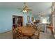Cozy dining room featuring vaulted ceilings, a fireplace, and views into the living room and entry at 1110 Fairfax St, Leesburg, FL 34748