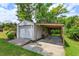 View of the garage exterior with carport, showcasing ample space and outdoor storage at 1110 Fairfax St, Leesburg, FL 34748