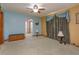 A cozy living room with blue walls, ceiling fan, and neutral carpet at 1110 Fairfax St, Leesburg, FL 34748
