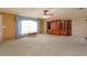 Expansive living room features a large window, cozy carpet, and a built-in wooden cabinet at 1110 Fairfax St, Leesburg, FL 34748