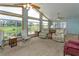 Bright living room with vaulted ceilings, ceiling fans, and large windows overlooking the outdoor scenery at 1110 Fairfax St, Leesburg, FL 34748