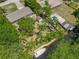Aerial view of the property showcasing lush landscaping, boat dock and canal access, and private backyard at 11114 Lake Eustis Dr, Leesburg, FL 34788