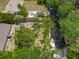 An aerial shot featuring a private dock with a boat, adjacent to a lush waterway at 11114 Lake Eustis Dr, Leesburg, FL 34788