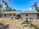 Spacious backyard featuring an outdoor seating area, grill, and lush landscaping perfect for entertaining guests at 11114 Lake Eustis Dr, Leesburg, FL 34788