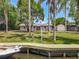 Secluded backyard with lush greenery, including a personal dock and boat for water access at 11114 Lake Eustis Dr, Leesburg, FL 34788