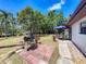 View of the backyard with patio, grill, and outdoor seating area, perfect for entertaining in this outdoor living space at 11114 Lake Eustis Dr, Leesburg, FL 34788